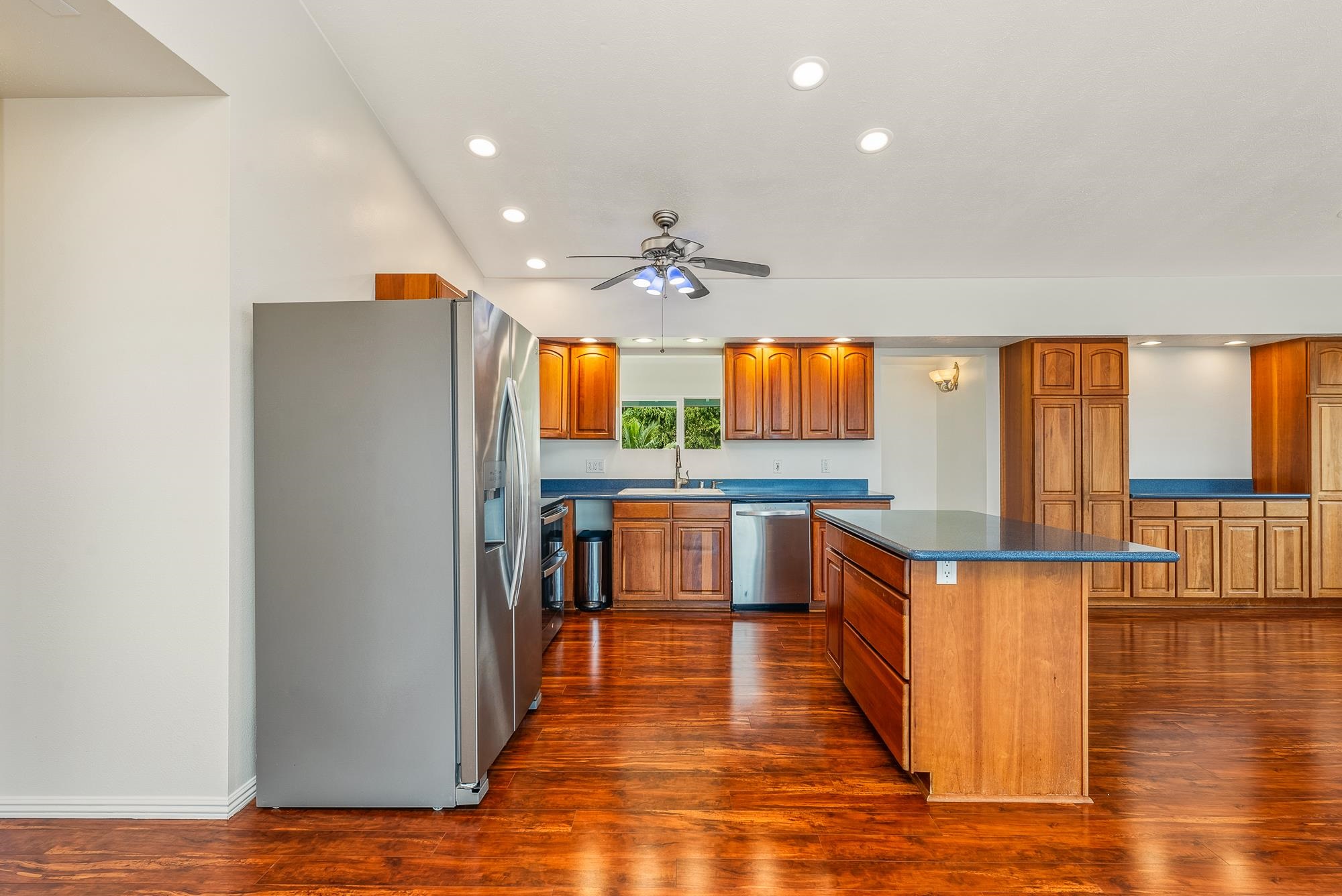 4535 Opana Place Haiku, HI 96708 - Photo 9 of 43 a kitchen with stainless steel appliances a refrigerator and wooden floor