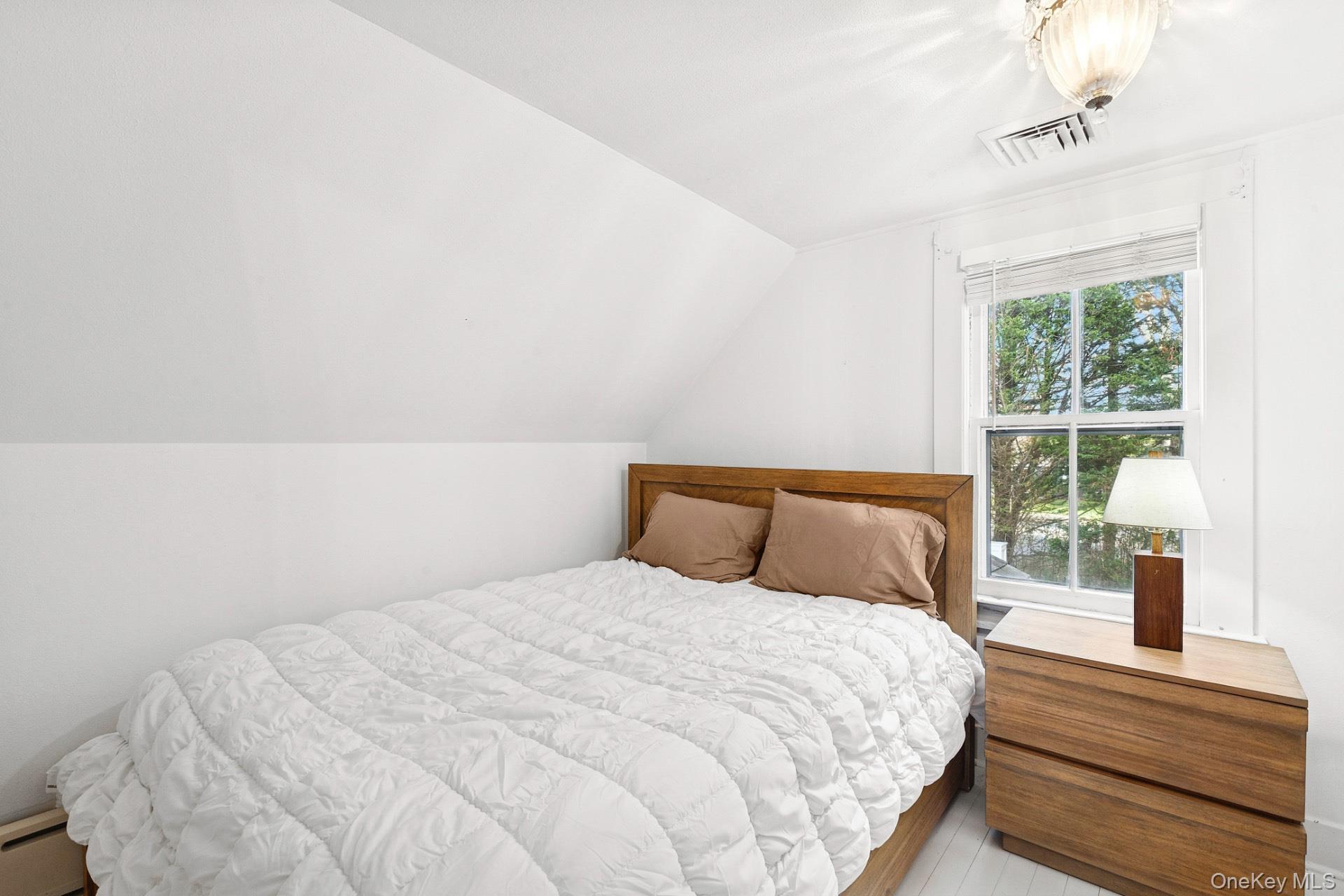 163 Three Mile Harbor Road East Hampton, NY 11937 - Photo 11 of 13 a bedroom with a bed and a window