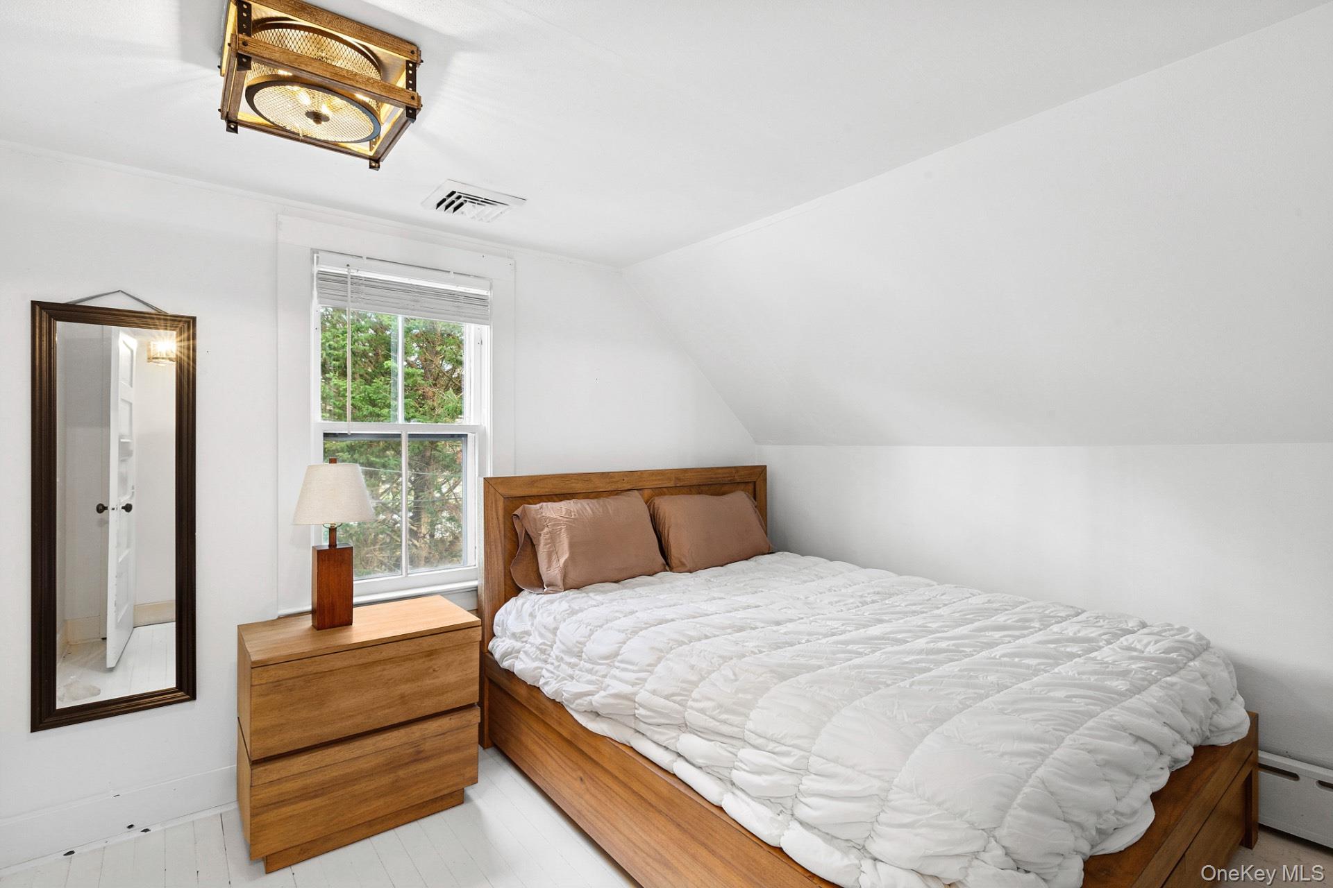 163 Three Mile Harbor Road East Hampton, NY 11937 - Photo 13 of 13 a bedroom with a bed and a window