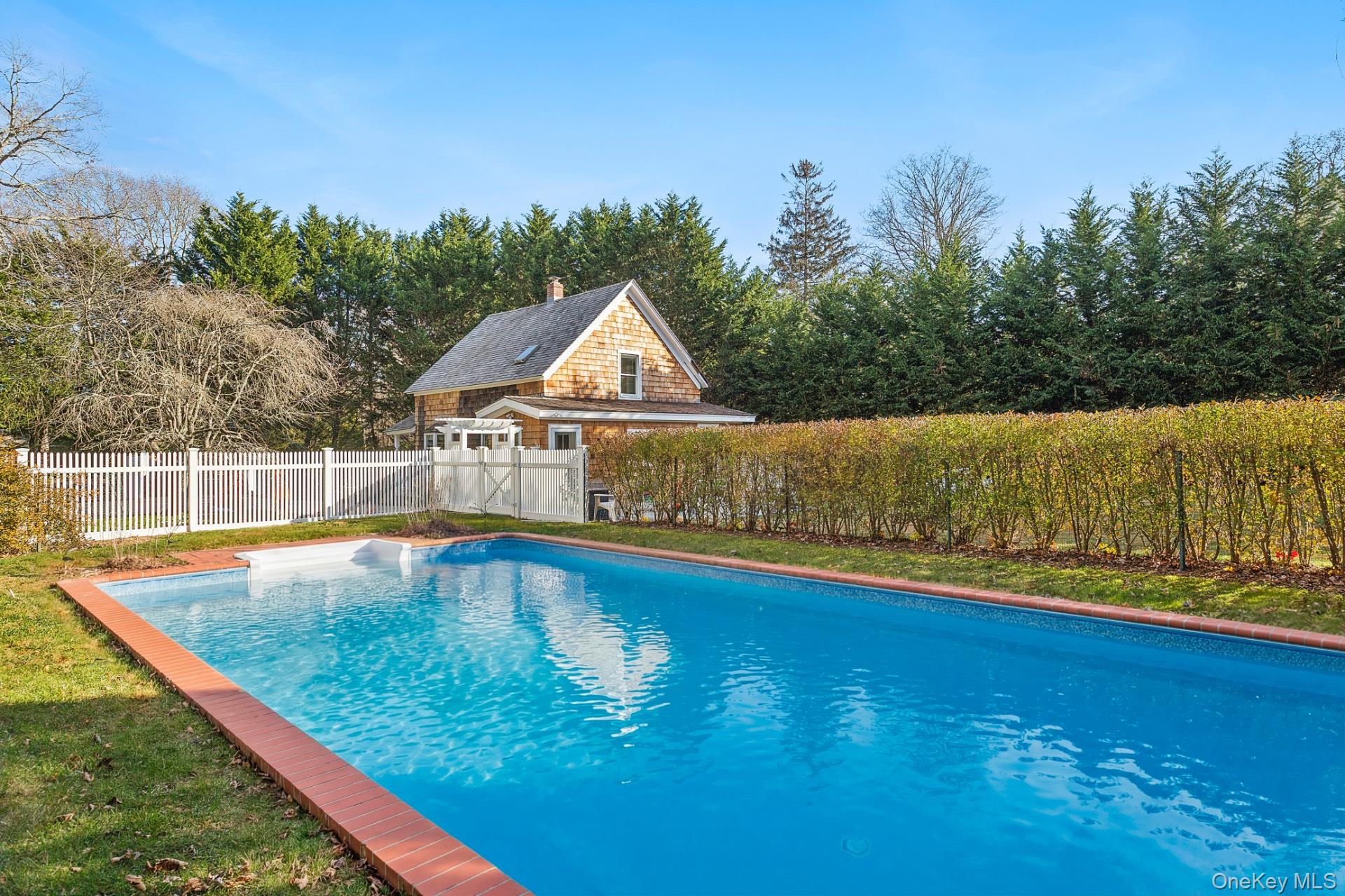 163 Three Mile Harbor Road East Hampton, NY 11937 - Photo 2 of 13 a view of a swimming pool with an outdoor space and seating area
