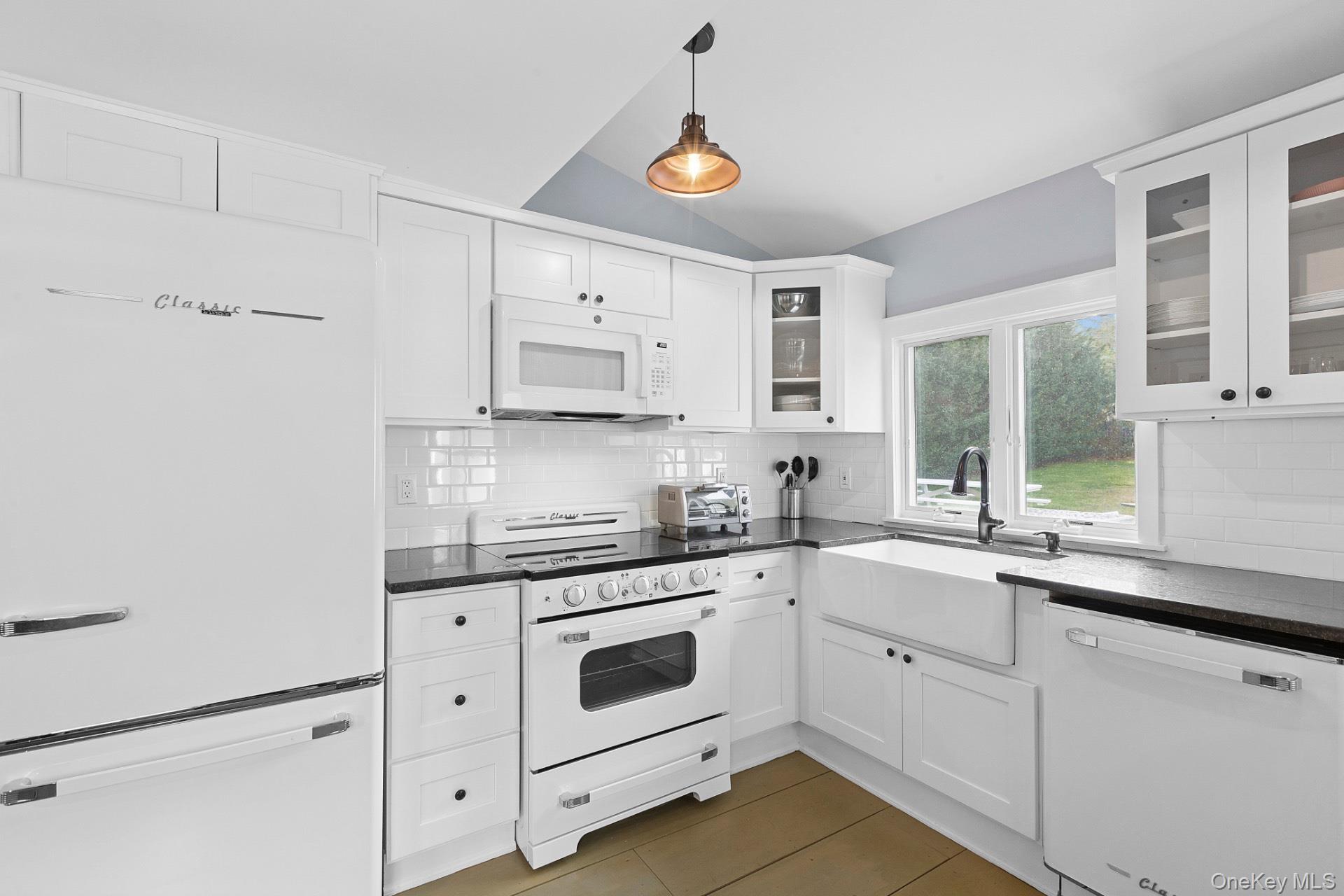 163 Three Mile Harbor Road East Hampton, NY 11937 - Photo 7 of 13 a kitchen with granite countertop white cabinets and white appliances