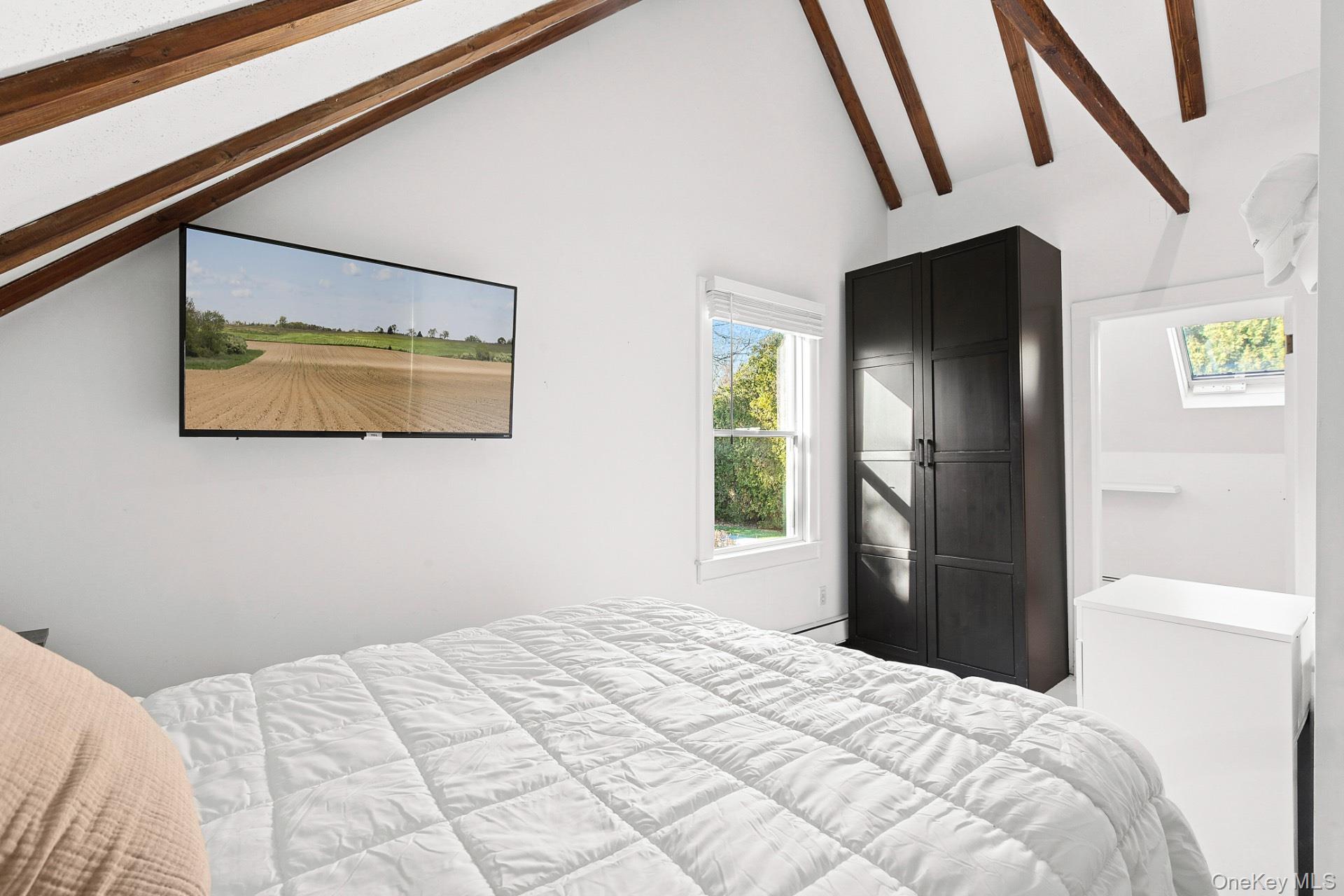 163 Three Mile Harbor Road East Hampton, NY 11937 - Photo 8 of 13 a bedroom with a bed and a window