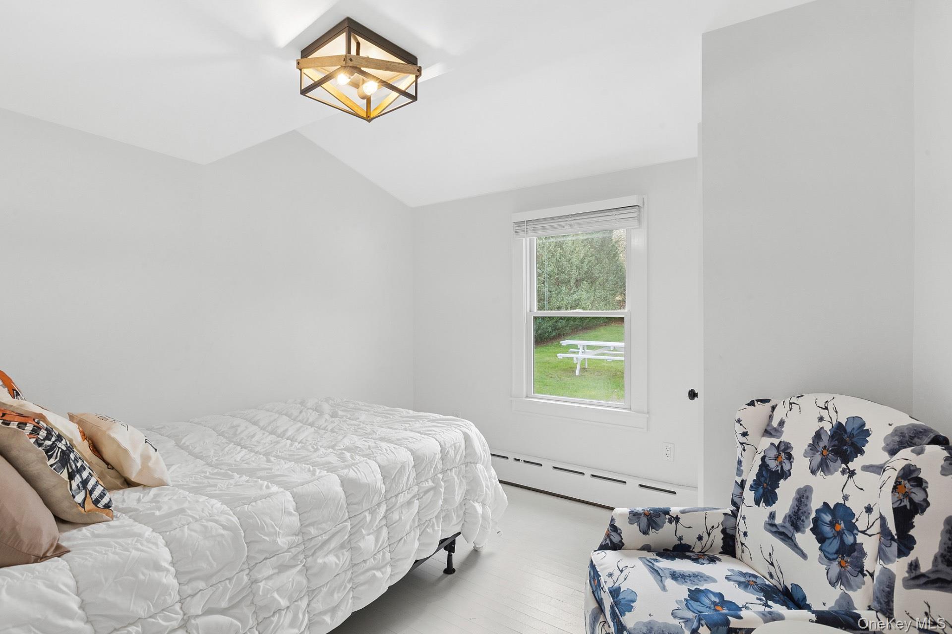 163 Three Mile Harbor Road East Hampton, NY 11937 - Photo 9 of 13 a bedroom with a bed and a window