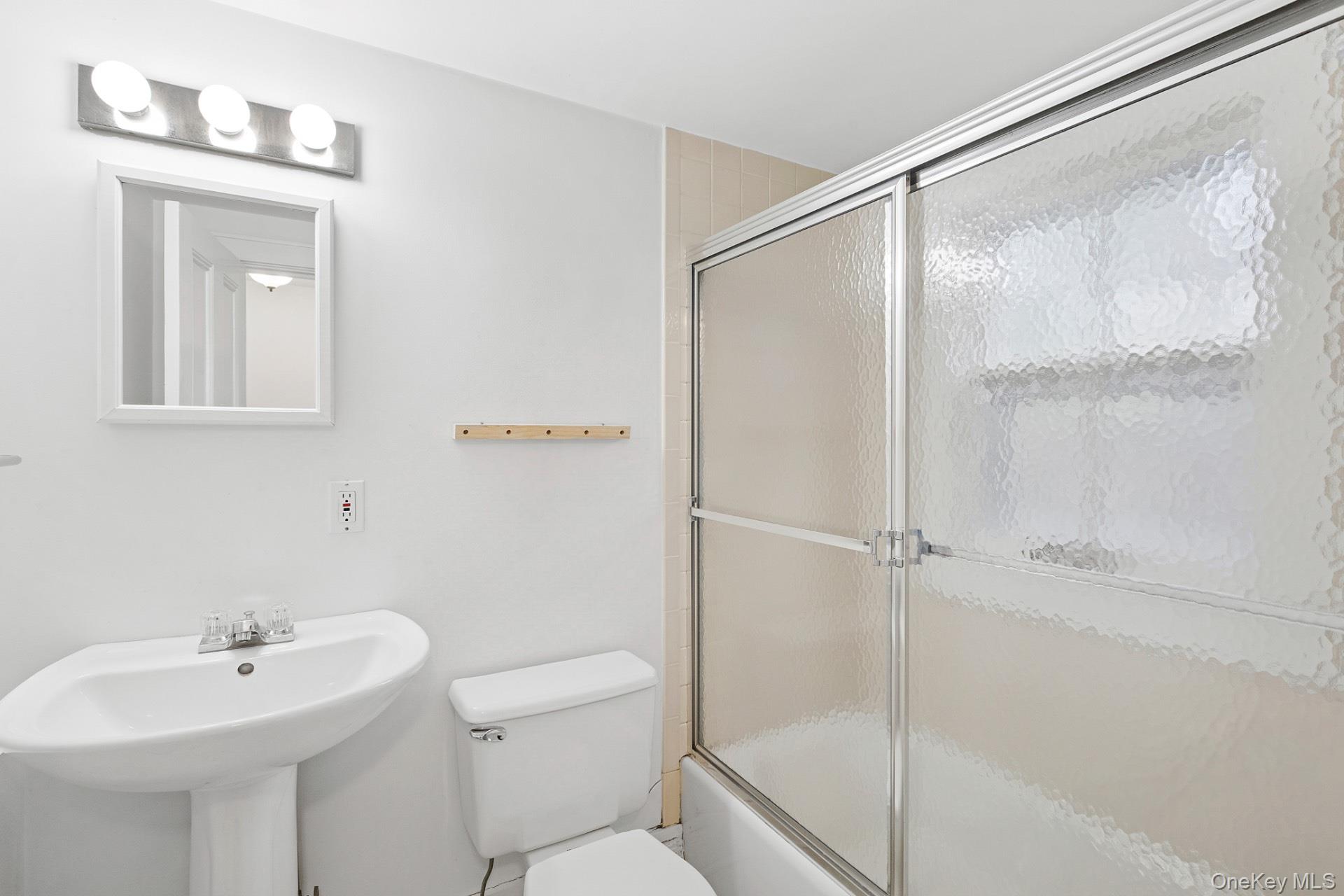 163 Three Mile Harbor Road East Hampton, NY 11937 - Photo 10 of 13 a bathroom with a bathtub shower sink vanity and toilet