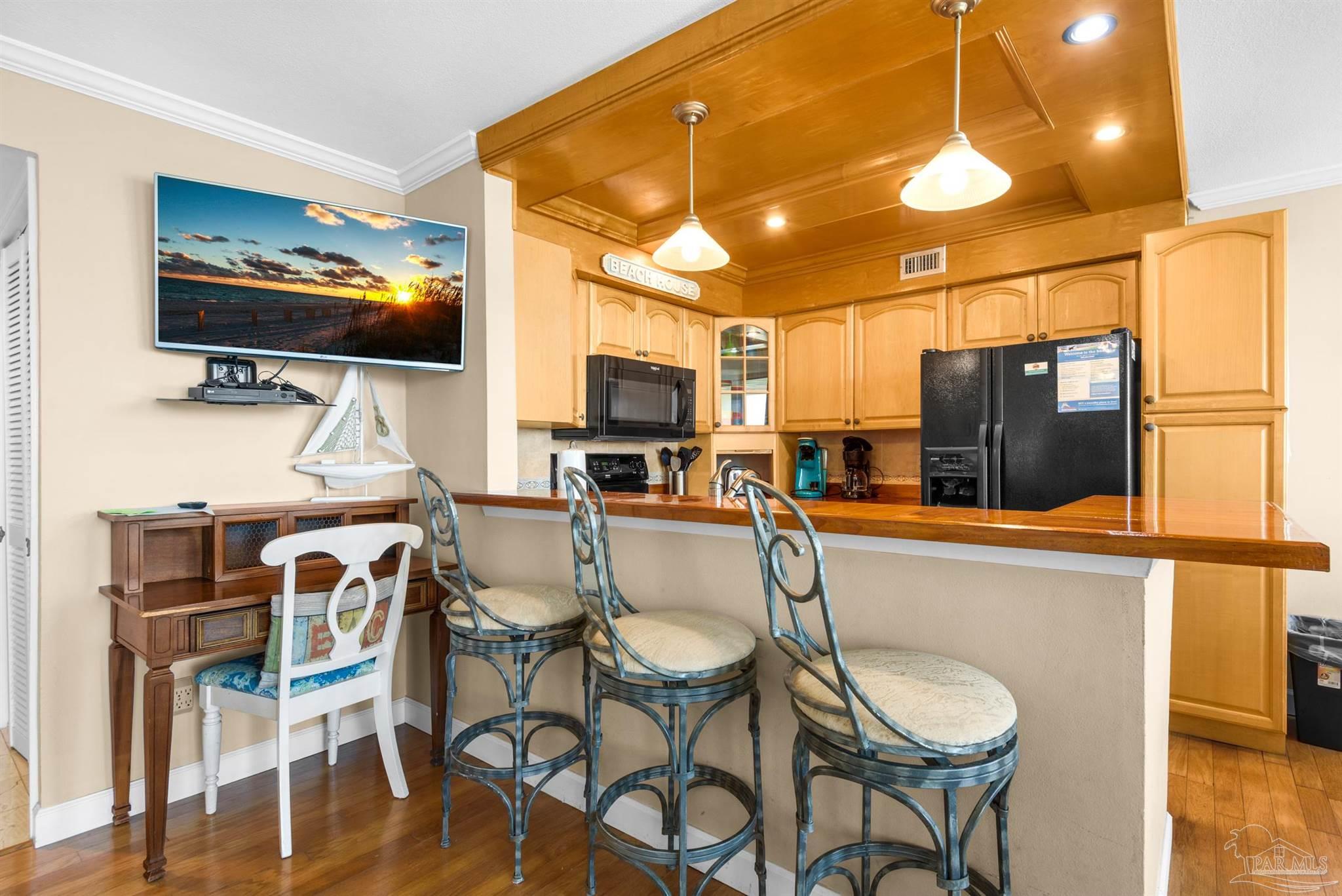 900 Fort Pickens Road, Unit 1053 Pensacola Beach, FL 32561 - Photo 12 of 57 a view of a dining room with furniture and wooden floor