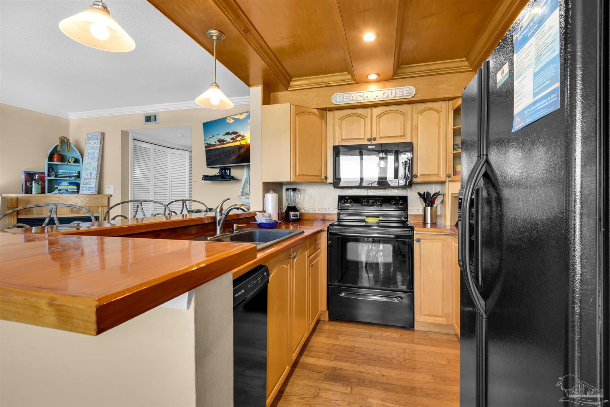 900 Fort Pickens Road, Unit 1053 Pensacola Beach, FL 32561 - Photo 13 of 57 a kitchen with stainless steel appliances granite countertop a refrigerator a stove and a sink