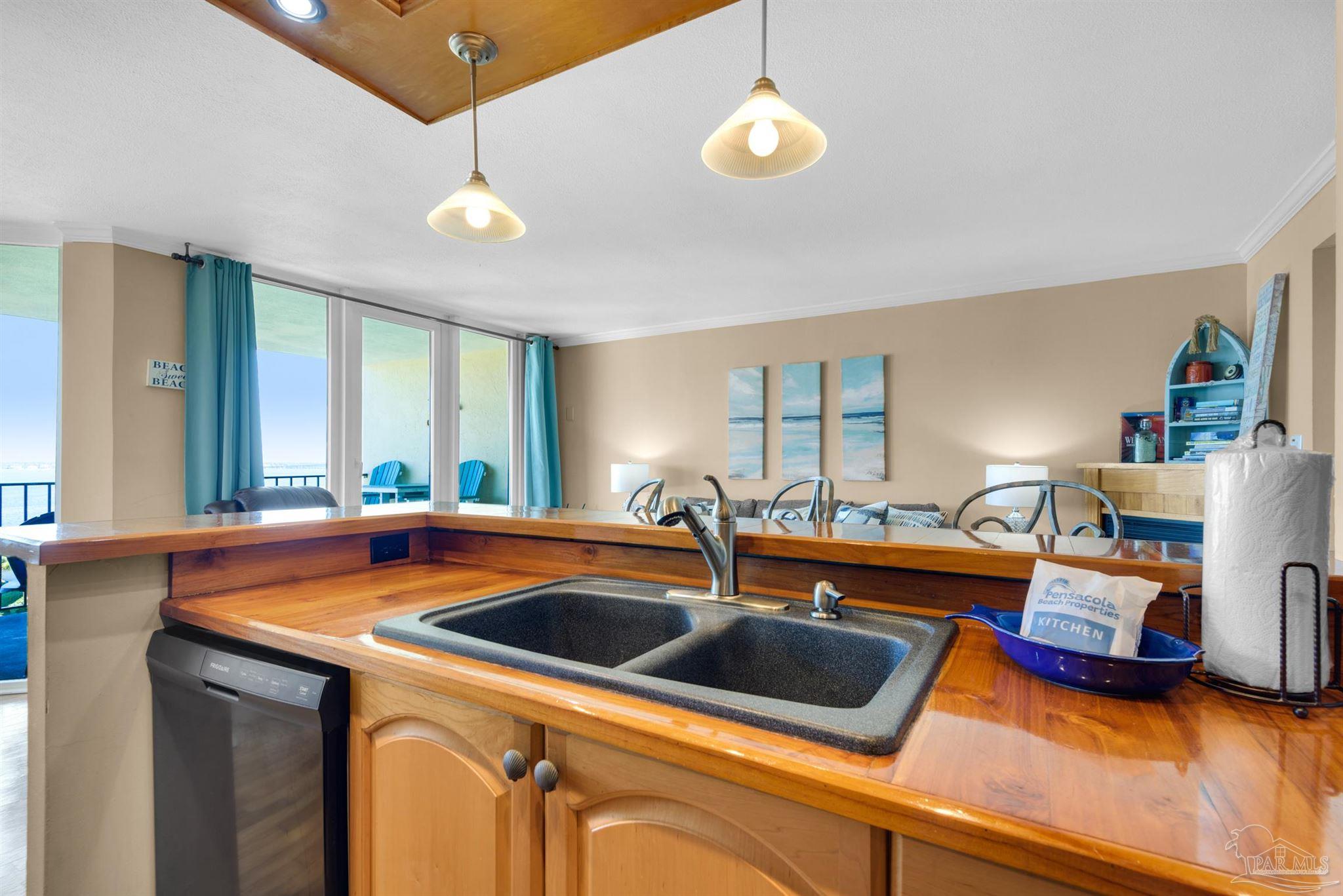 900 Fort Pickens Road, Unit 1053 Pensacola Beach, FL 32561 - Photo 14 of 57 a kitchen that has a sink and a stove