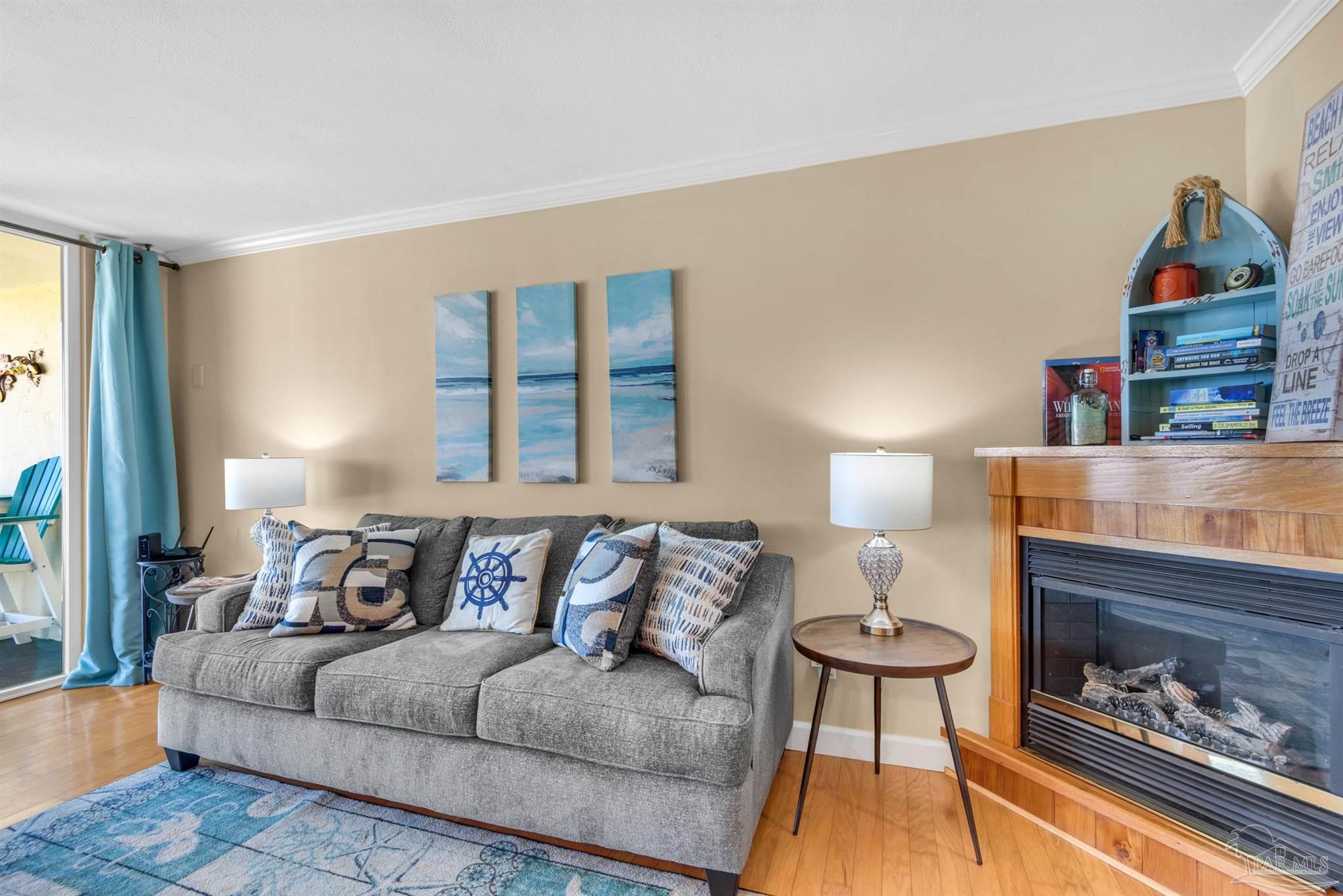 900 Fort Pickens Road, Unit 1053 Pensacola Beach, FL 32561 - Photo 2 of 57 a living room with furniture and a fireplace