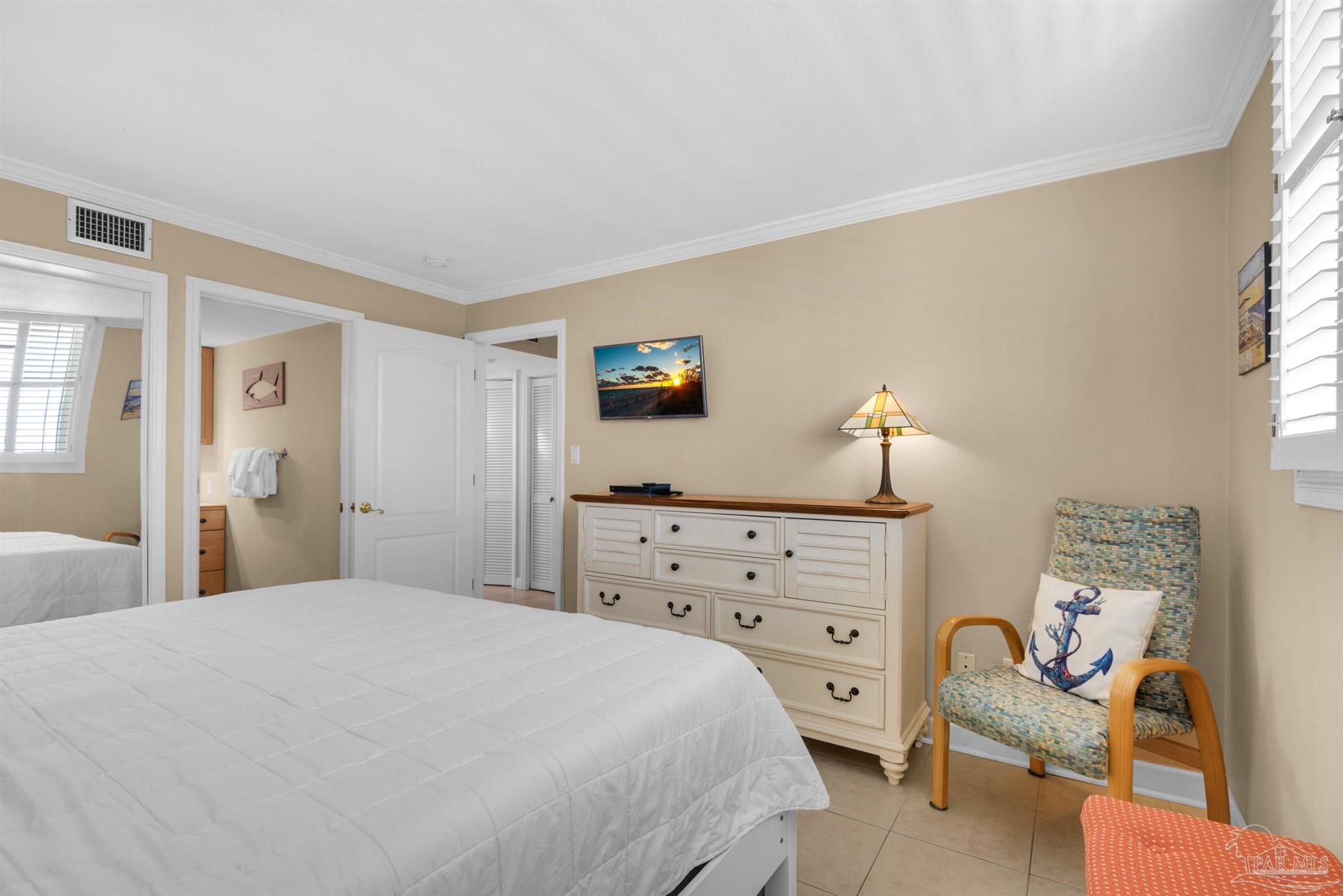 900 Fort Pickens Road, Unit 1053 Pensacola Beach, FL 32561 - Photo 22 of 57 a bedroom with a bed and a dresser