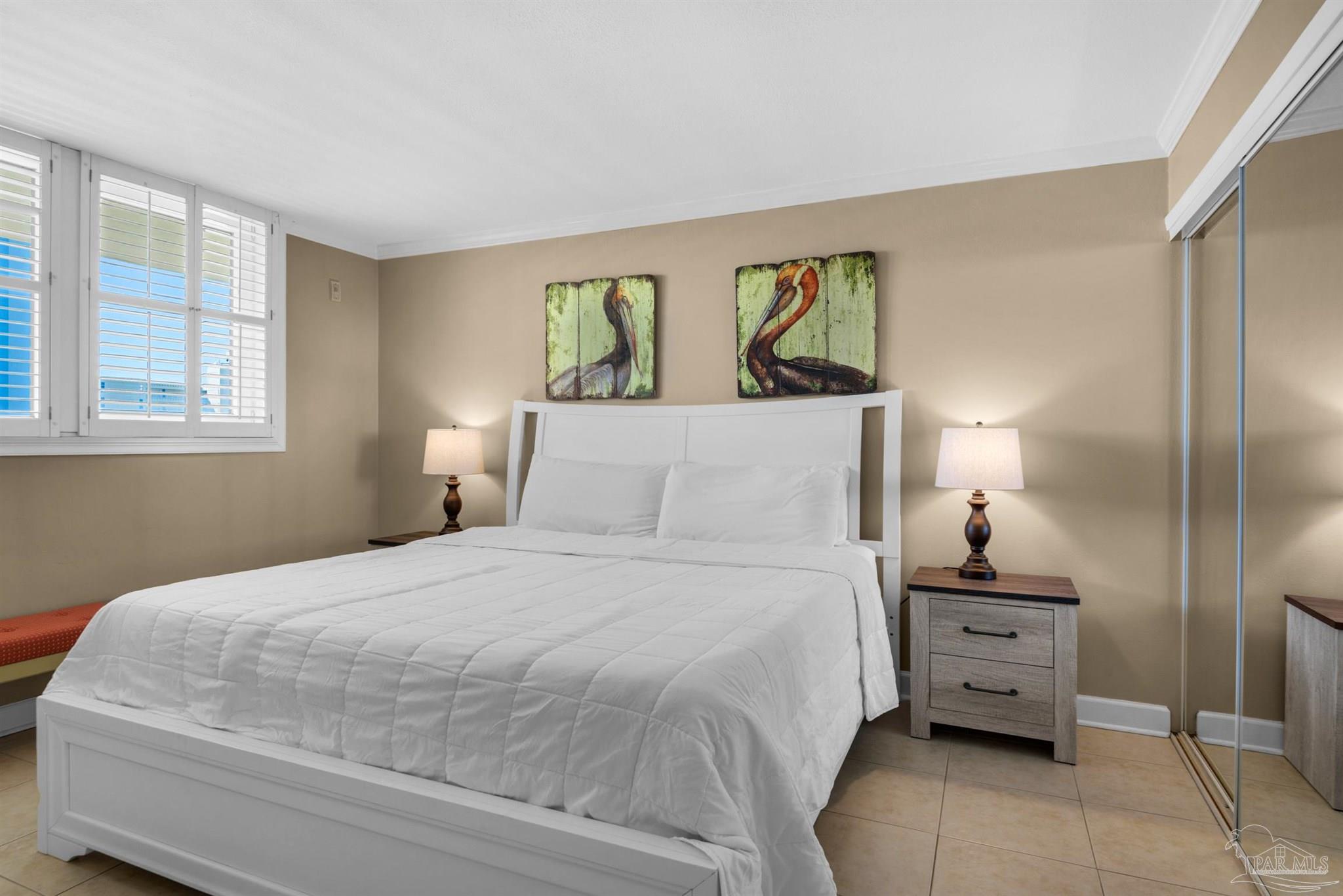 900 Fort Pickens Road, Unit 1053 Pensacola Beach, FL 32561 - Photo 23 of 57 a bedroom with a bed and dresser