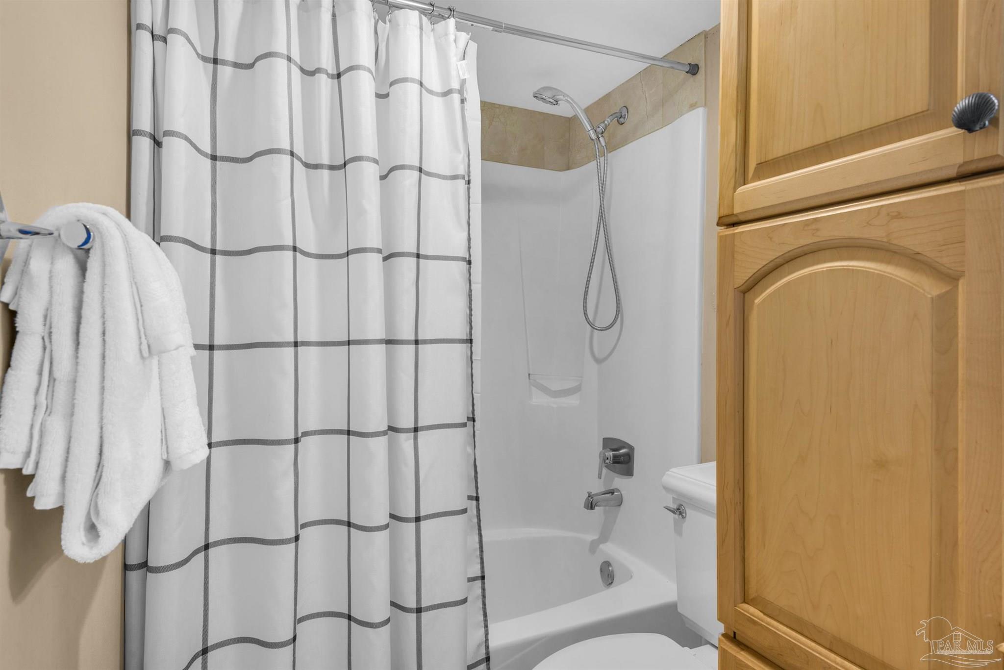 900 Fort Pickens Road, Unit 1053 Pensacola Beach, FL 32561 - Photo 25 of 57 a bathroom with a shower curtain