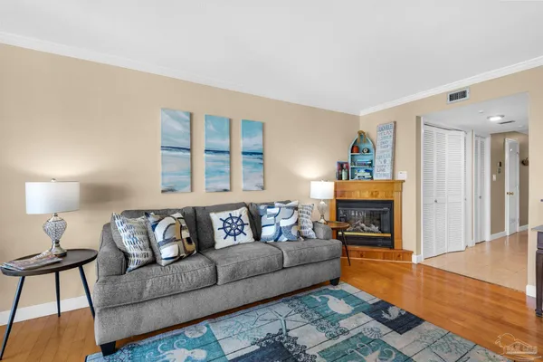 a living room with furniture and kitchen view
