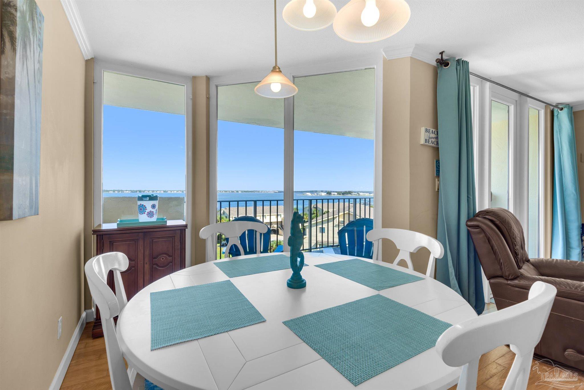900 Fort Pickens Road, Unit 1053 Pensacola Beach, FL 32561 - Photo 9 of 57 a view of a dining room with furniture window and wooden floor