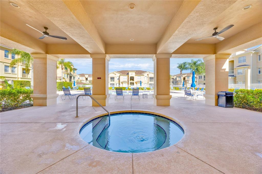 804 Terrace Ridge Circle, Unit 804 Davenport, FL 33896 - Photo 16 of 18 a view of a swimming pool with outdoor seating