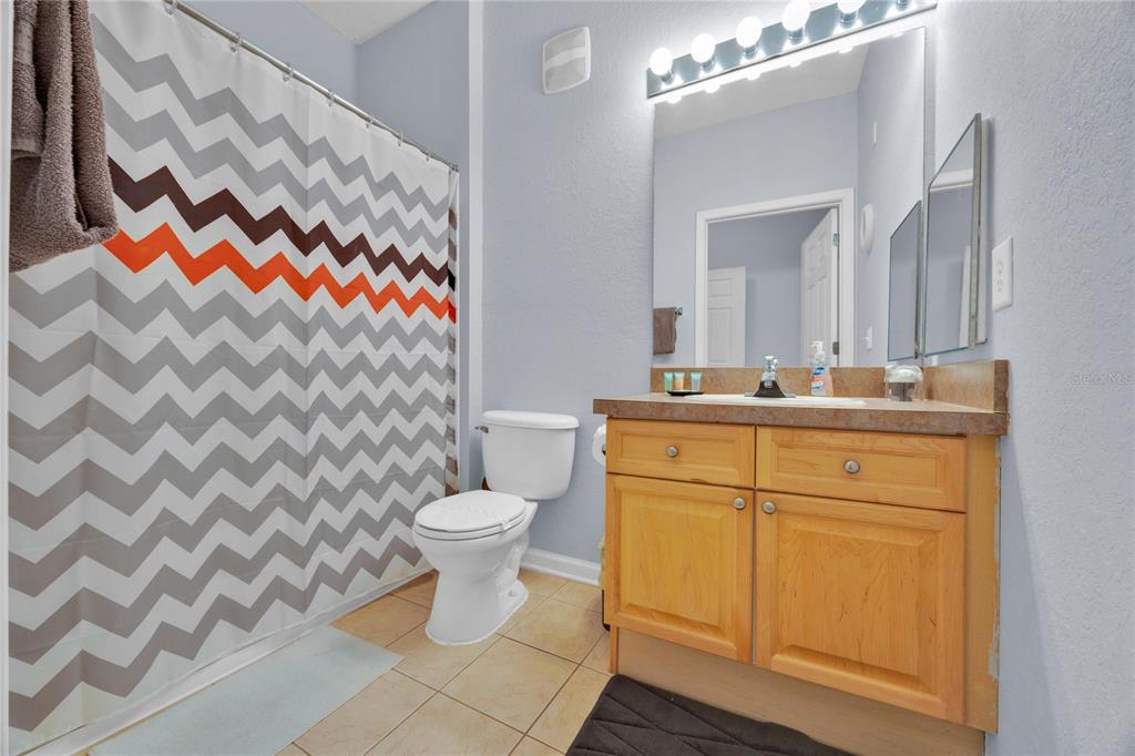 804 Terrace Ridge Circle, Unit 804 Davenport, FL 33896 - Photo 18 of 18 a bathroom with a sink toilet and shower