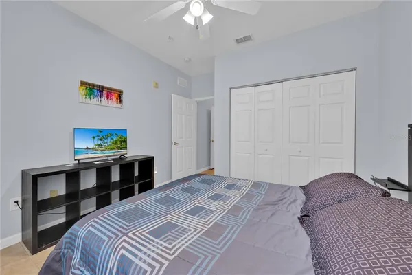 a bedroom with a bed and a chandelier
