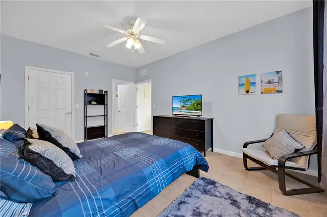 a bedroom with a bed and a chandelier