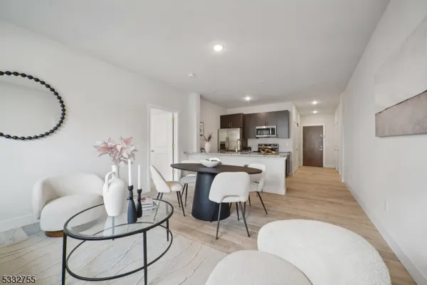 a living room with furniture and kitchen view