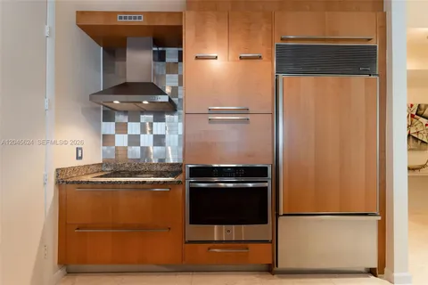 a kitchen with a stove and a refrigerator