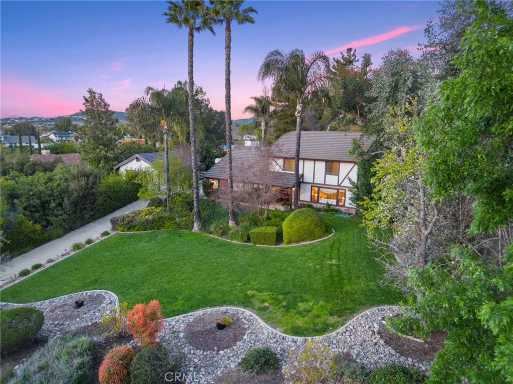a view of a garden with a house