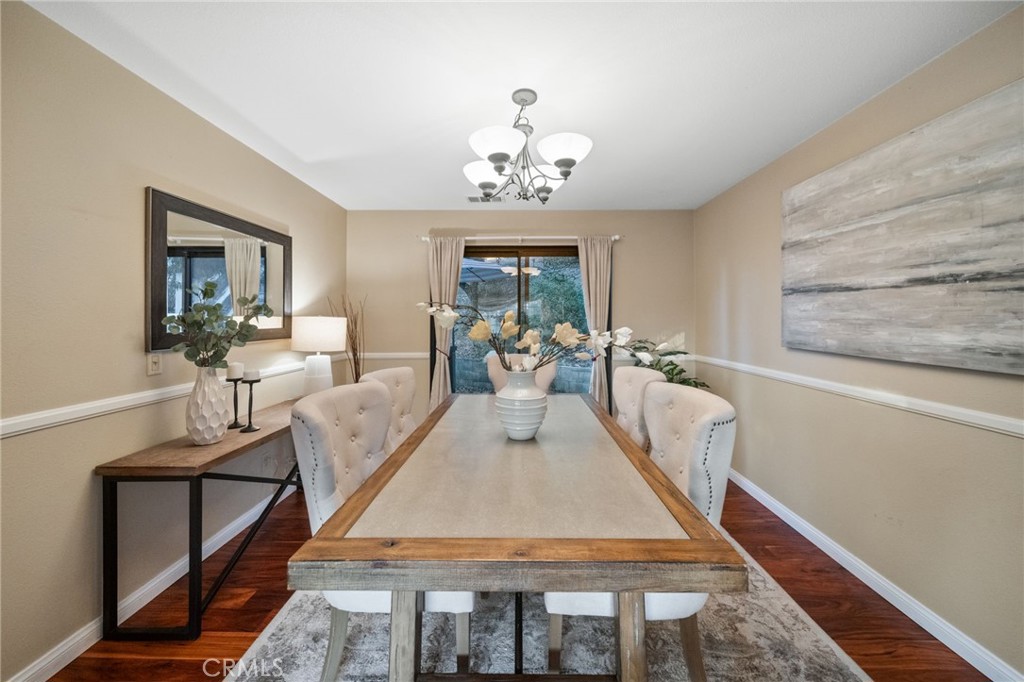 40440 Calle Torcida Temecula, CA 92591 - Photo 12 of 48 a living room with furniture a chandelier and wooden floor