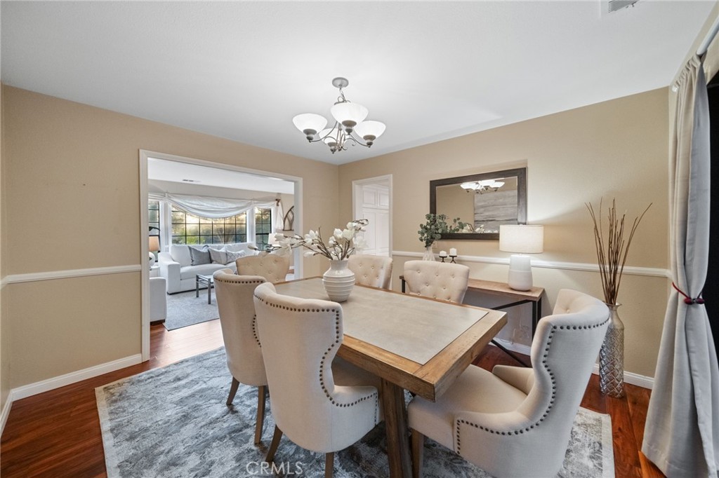 40440 Calle Torcida Temecula, CA 92591 - Photo 13 of 48 a view of a dining room with furniture a rug and wooden floor