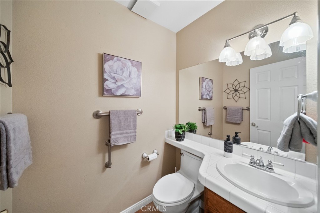 40440 Calle Torcida Temecula, CA 92591 - Photo 15 of 48 a bathroom with a sink a mirror and a toilet