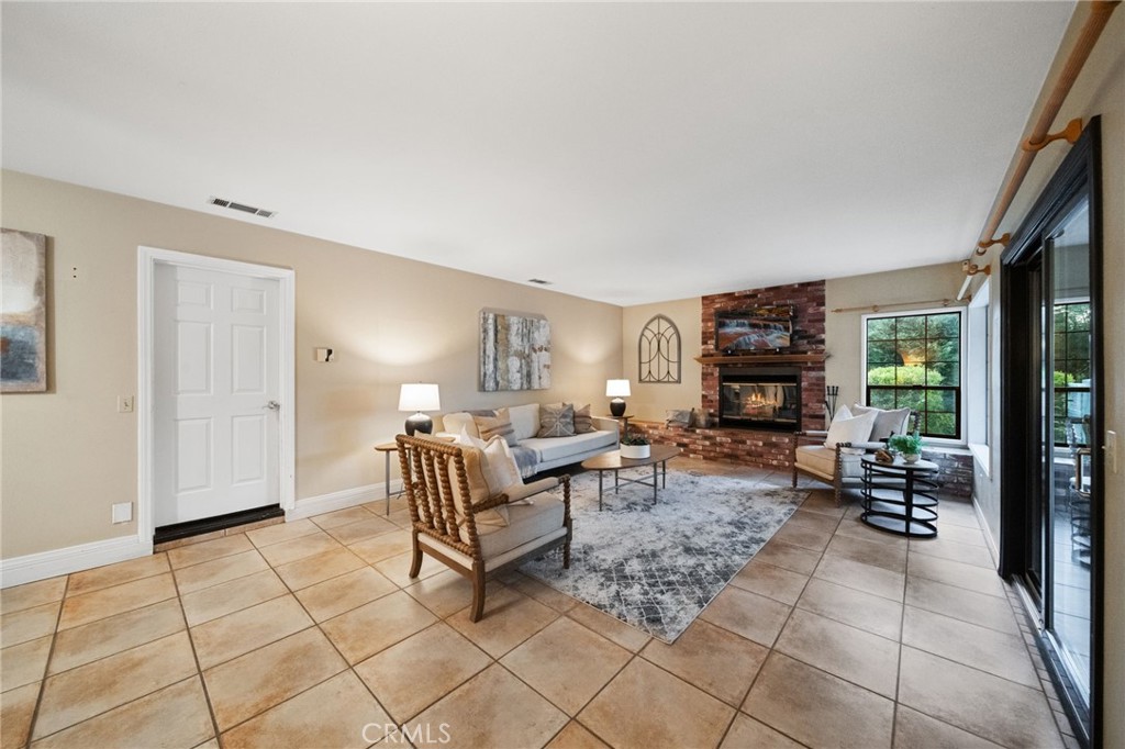 40440 Calle Torcida Temecula, CA 92591 - Photo 21 of 48 a living room with furniture a fireplace and a large window