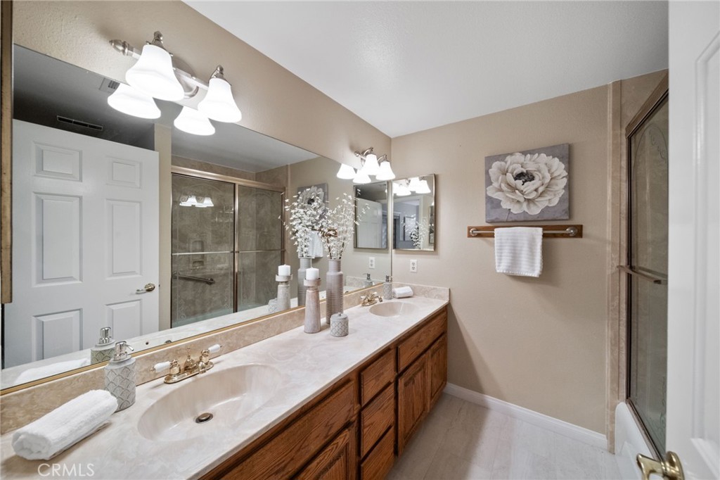 40440 Calle Torcida Temecula, CA 92591 - Photo 29 of 48 a bathroom with a sink a large mirror and a shower