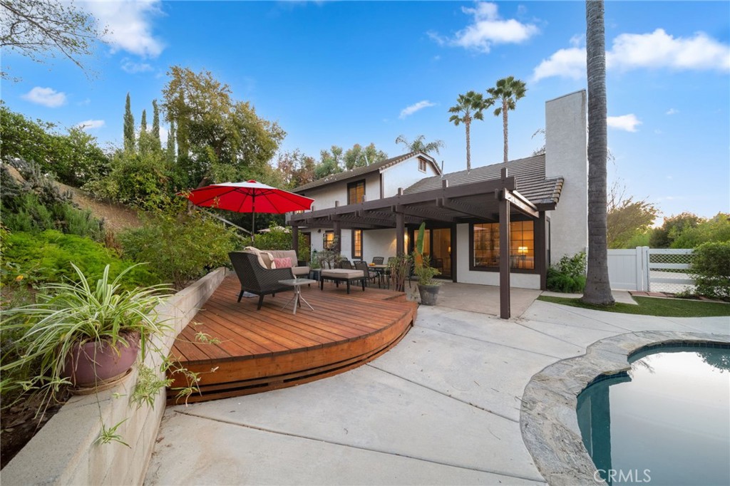 40440 Calle Torcida Temecula, CA 92591 - Photo 37 of 48 a patio with a table and chairs under an umbrella