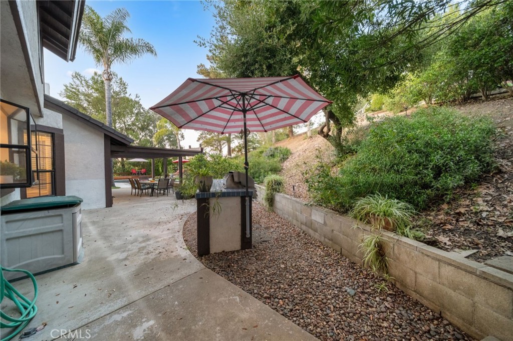40440 Calle Torcida Temecula, CA 92591 - Photo 44 of 48 a view of a patio with table and chairs under an umbrella