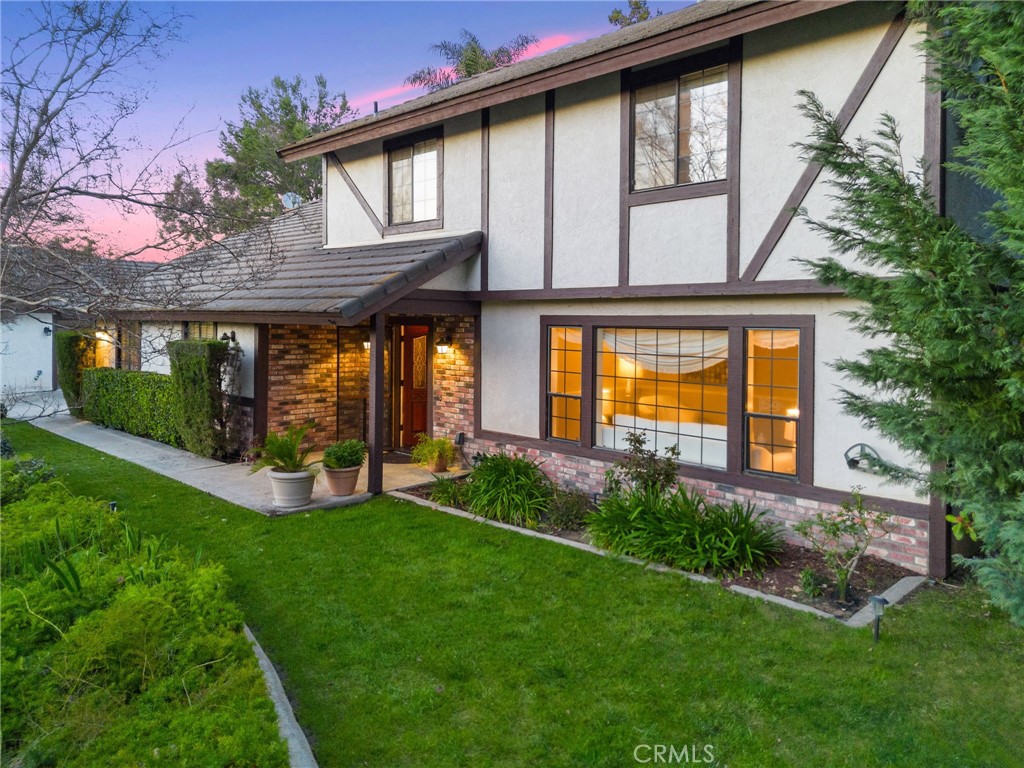40440 Calle Torcida Temecula, CA 92591 - Photo 7 of 48 a view of a house with brick walls and a yard with plants