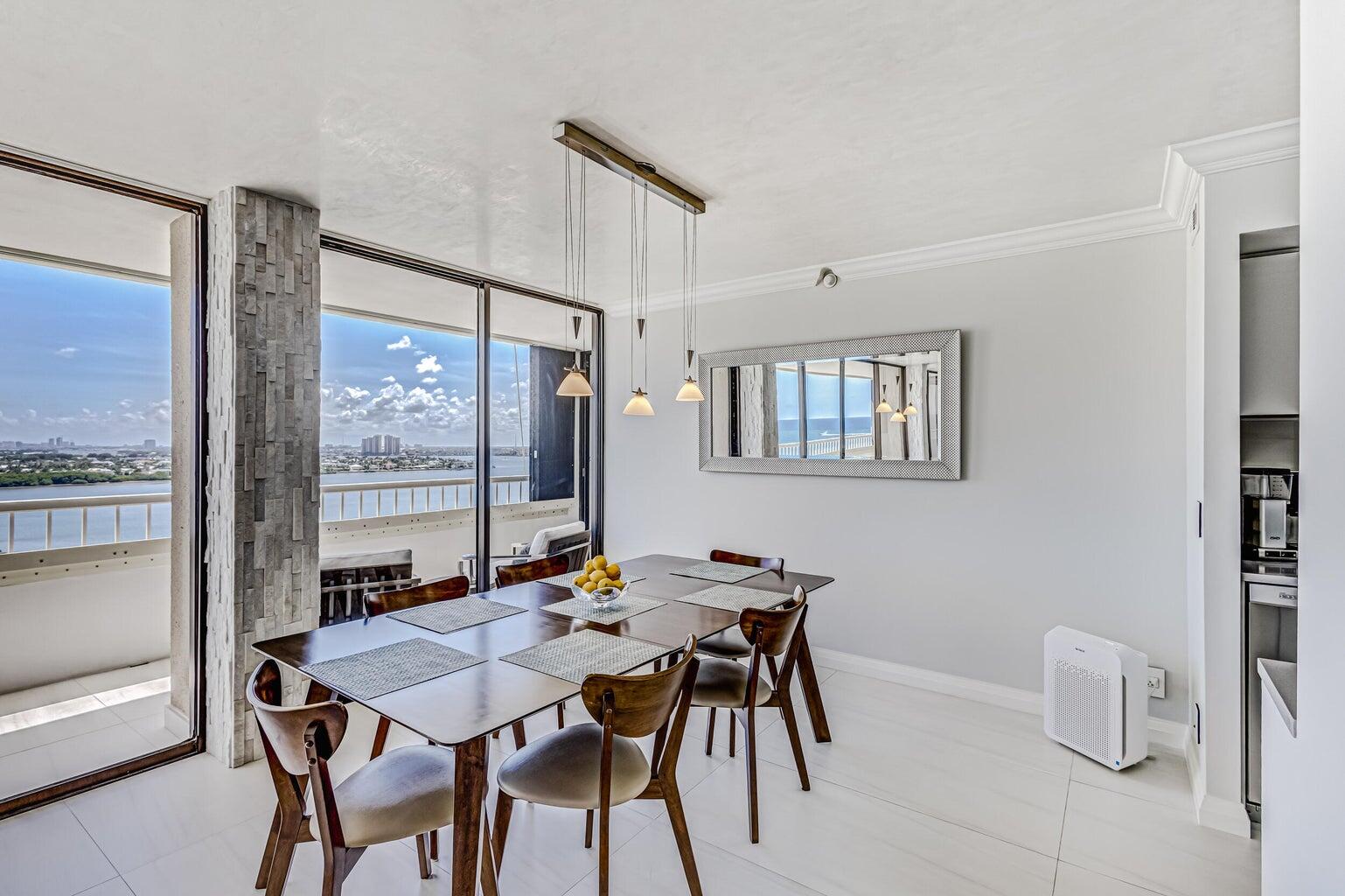 5280 North Ocean Drive, Unit 12F Singer Island, FL 33404 - Photo 11 of 66 a view of a dining room with furniture window and outside view