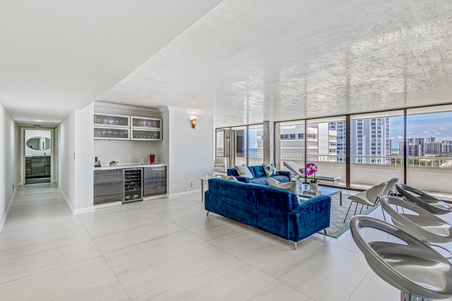 5280 North Ocean Drive, Unit 12F Singer Island, FL 33404 - Photo 2 of 66 a living room with furniture a flat screen tv and a large window