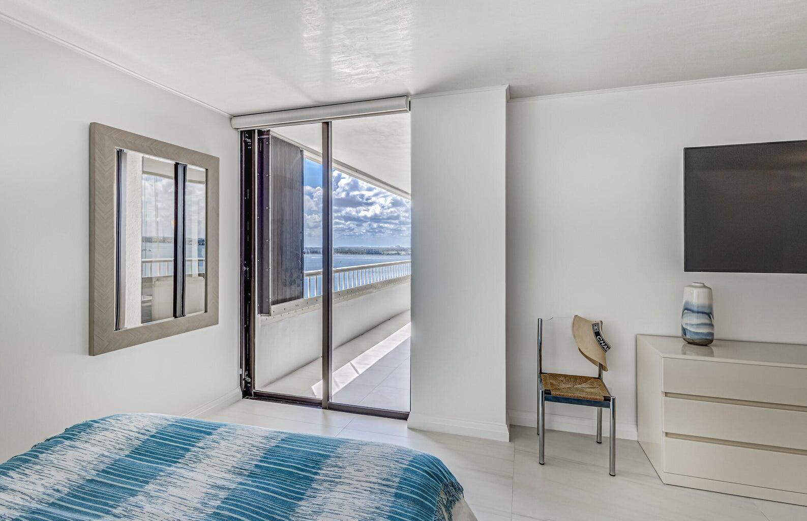 5280 North Ocean Drive, Unit 12F Singer Island, FL 33404 - Photo 25 of 66 a bedroom with a bed and a flat screen tv