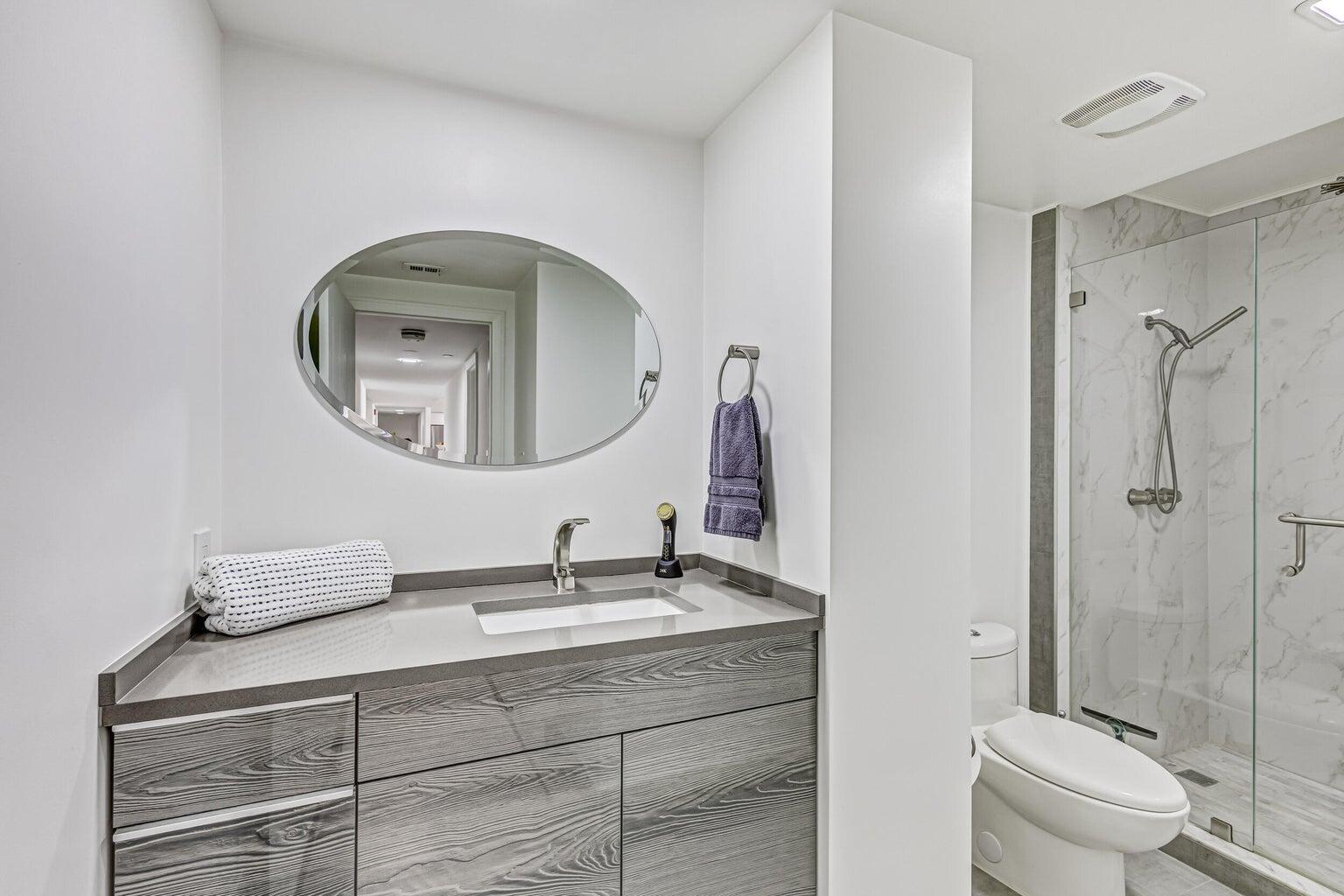 5280 North Ocean Drive, Unit 12F Singer Island, FL 33404 - Photo 30 of 66 a bathroom with a toilet sink and mirror