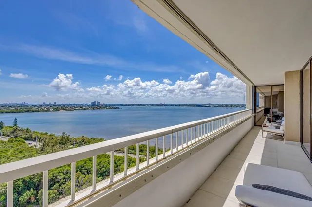 a spacious bathroom with a granite countertop sink a toilet and mirror