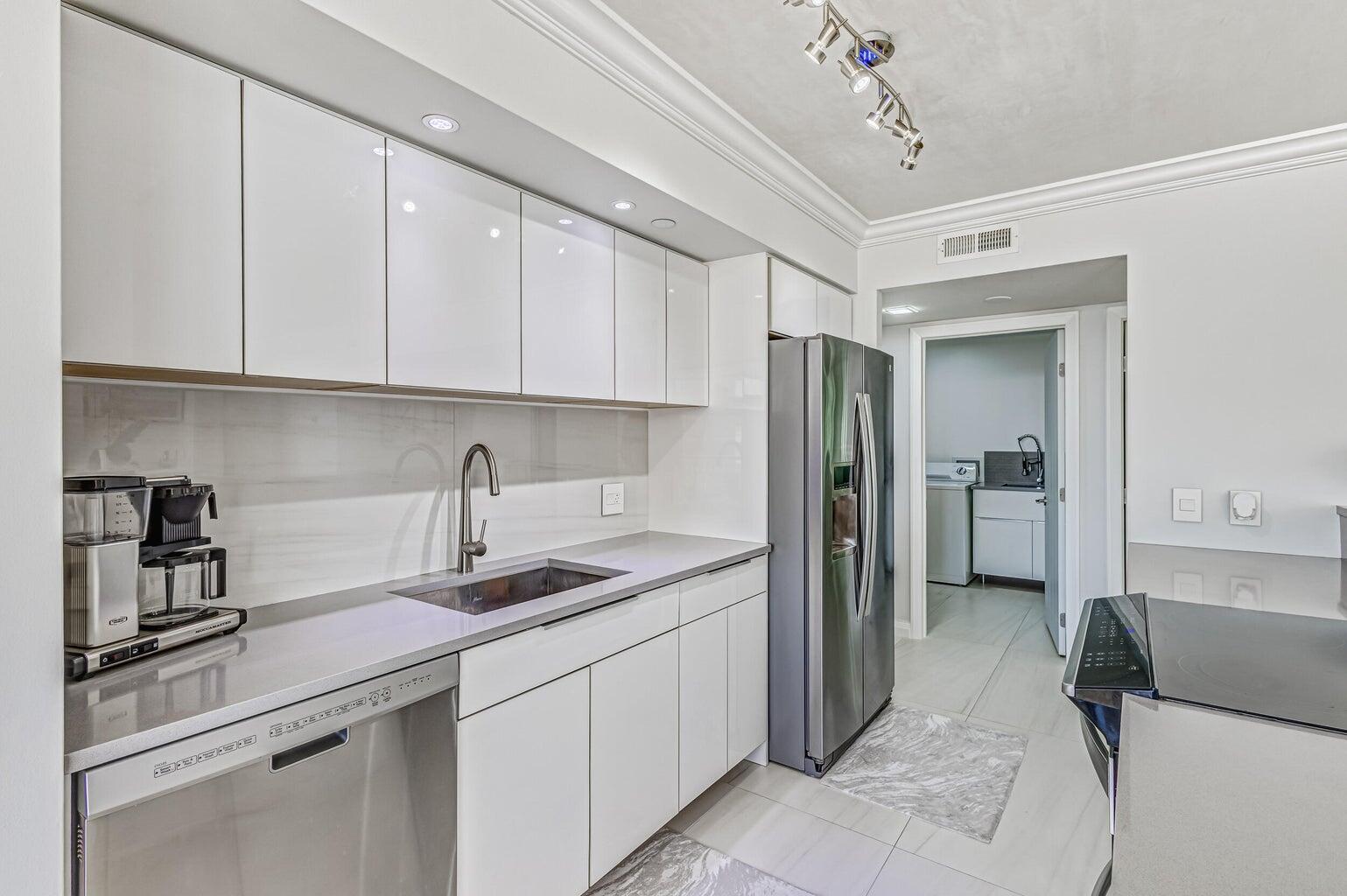 5280 North Ocean Drive, Unit 12F Singer Island, FL 33404 - Photo 43 of 66 a kitchen with a sink appliances and cabinets
