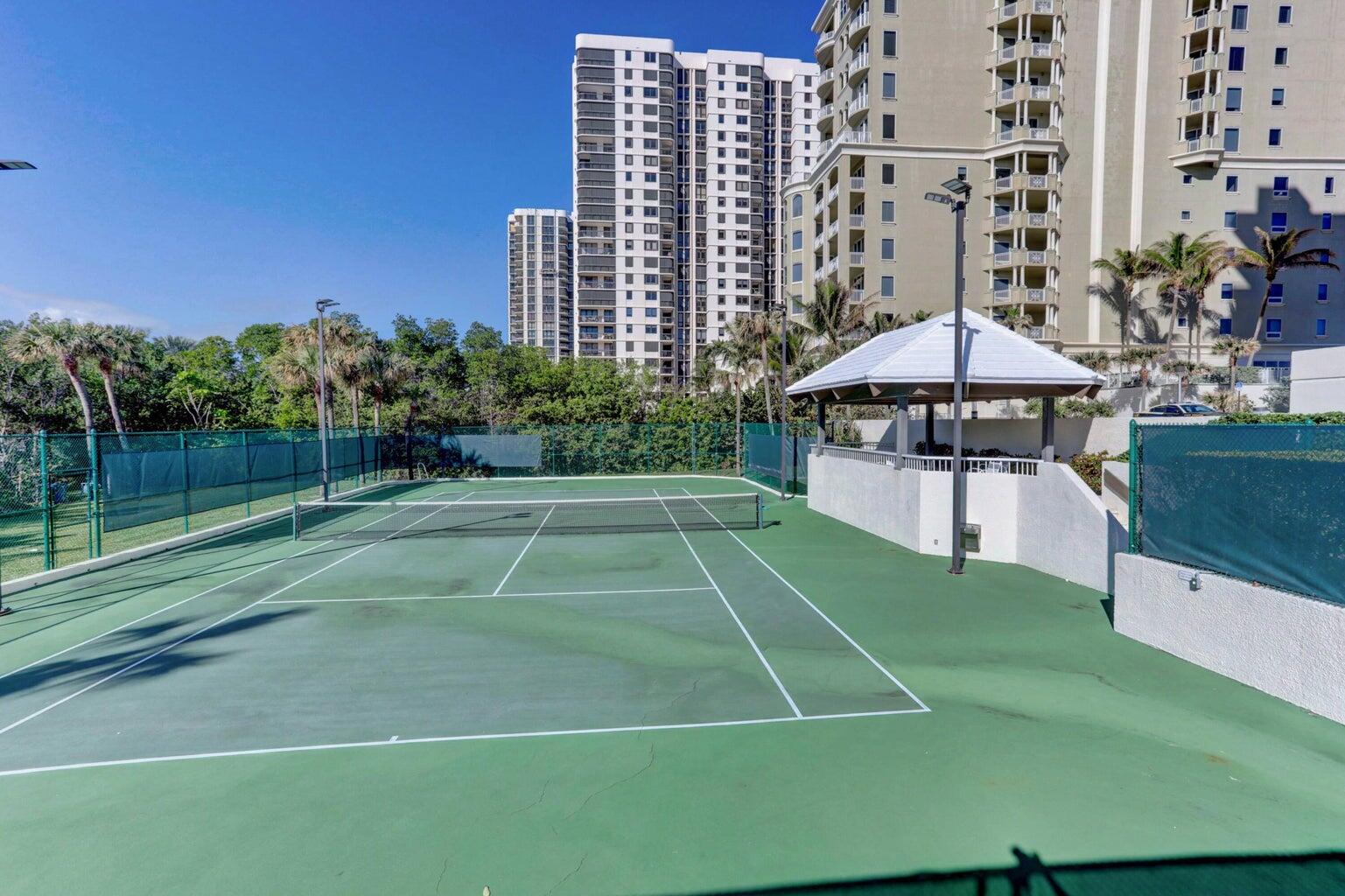5280 North Ocean Drive, Unit 12F Singer Island, FL 33404 - Photo 61 of 66 a view of a tennis ground with a swimming pool