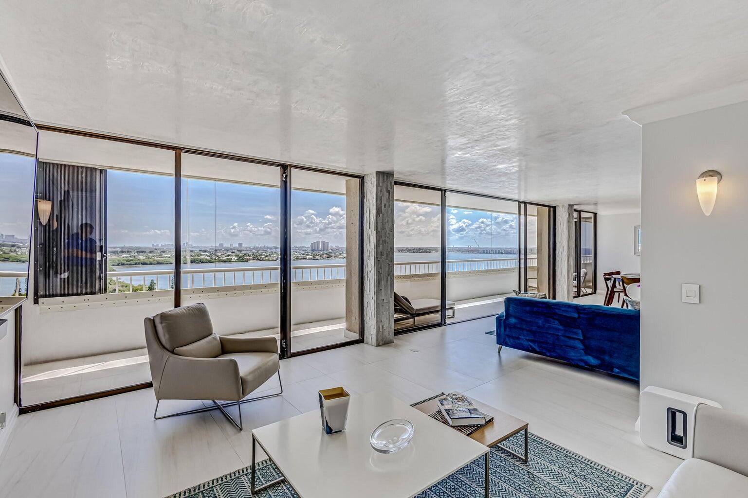 5280 North Ocean Drive, Unit 12F Singer Island, FL 33404 - Photo 7 of 66 a living room with furniture and a floor to ceiling window