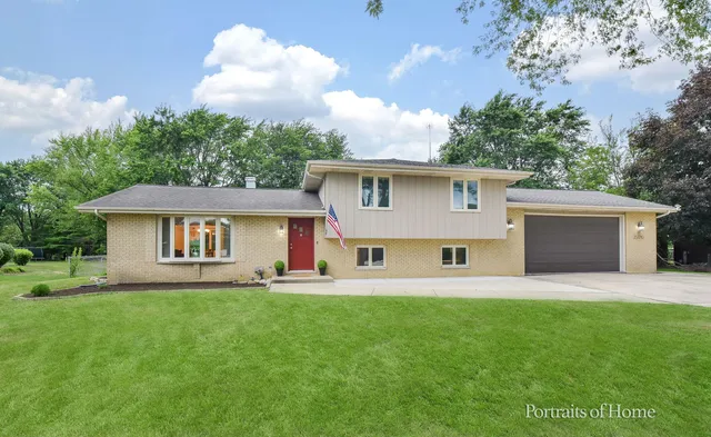 a front view of house with yard and trees