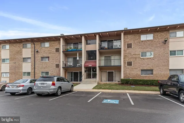 a view of a car parked in front of a brick building