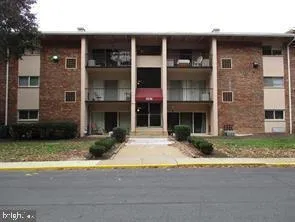 a front view of a brick house with a yard and a garage