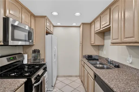 a kitchen with stainless steel appliances granite countertop a stove and a refrigerator
