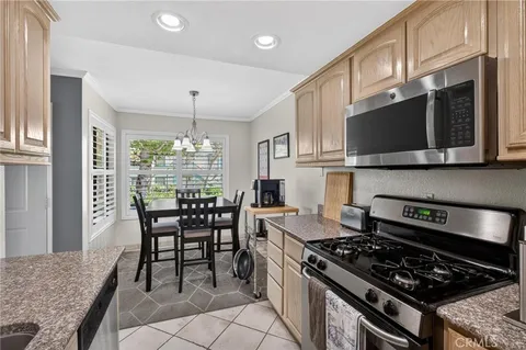 a kitchen with stainless steel appliances kitchen island granite countertop a stove a sink and a microwave