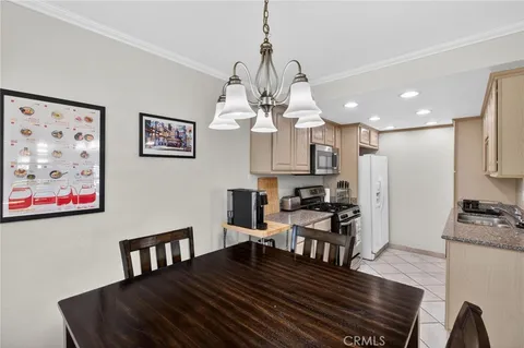 a view of a dining room with furniture a chandelier and wooden floor