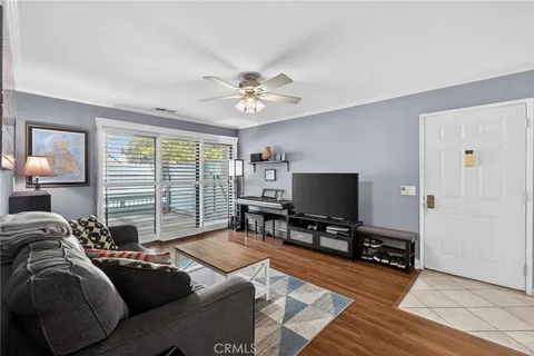 a living room with furniture a large window and a flat screen tv