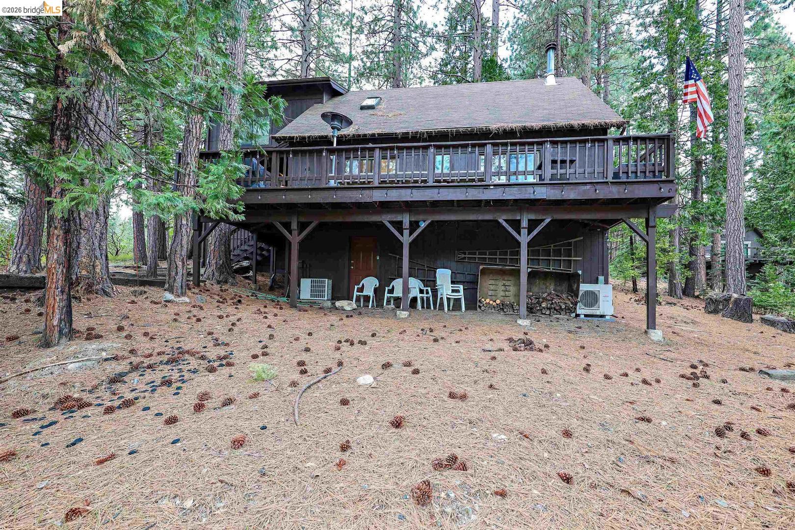 26600 Inyo Drive Cold Springs, CA 95335 - Photo 37 of 38 a view of a wooden house with a yard and furniture