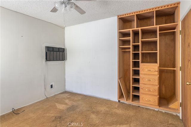 a view of an empty room with a ceiling fan