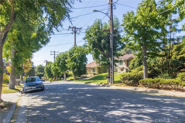 a view of street with parked cars